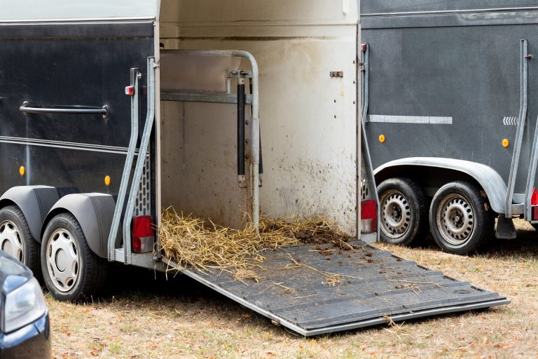 Rider sweeping the ramp to clean a horsebox before returning it to the hire company